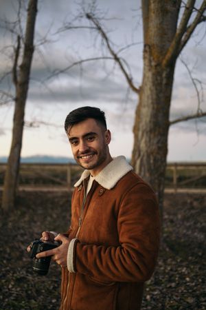 Portrait of a photographer taking photos in the countryside