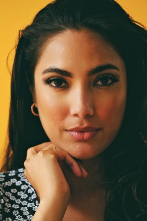 Headshot of Hispanic woman in yellow room, vertical
