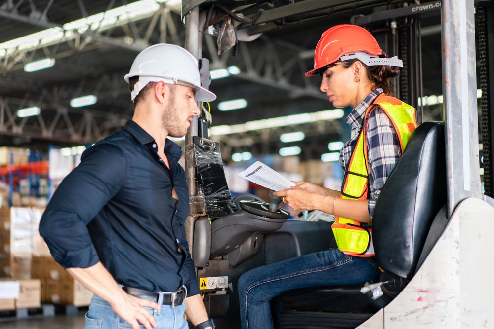Two colleagues going through checklist in distribution center