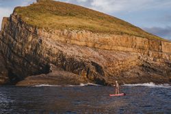 Woman on paddleboard floating in sea