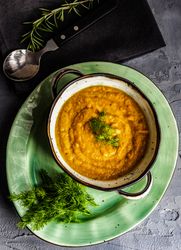 Top view of hearty pumpkin soup with garnish 