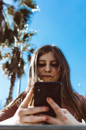 Teen girl looking at her smartphone.