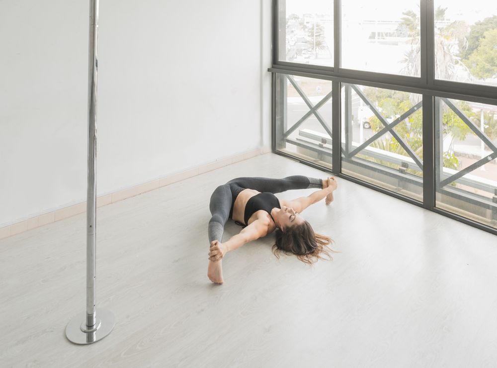 Flexible woman stretching in studio