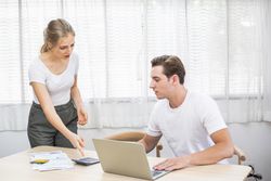 Stressed young couple discussing bills