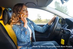 Woman talking on cell phone in vehicle 0g2n8b