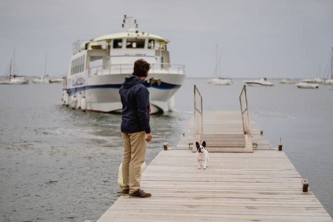 Man with dog on pier