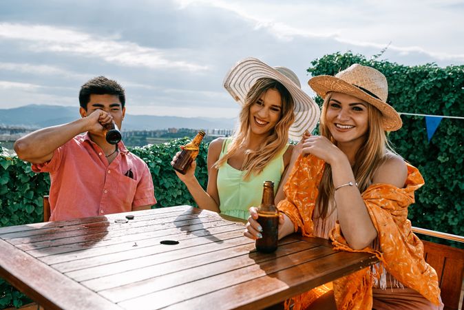 a group of young people having a good time in a summer day and cheering with beer