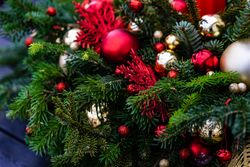 Close up of Christmas table center piece with pine branch and ornaments