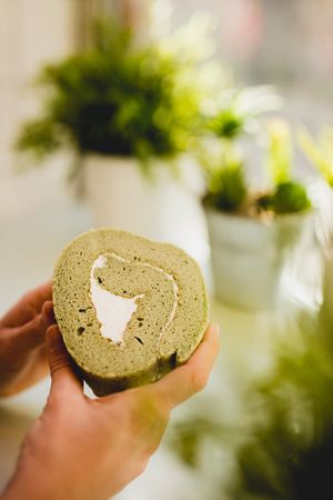 Hand holding matcha roll