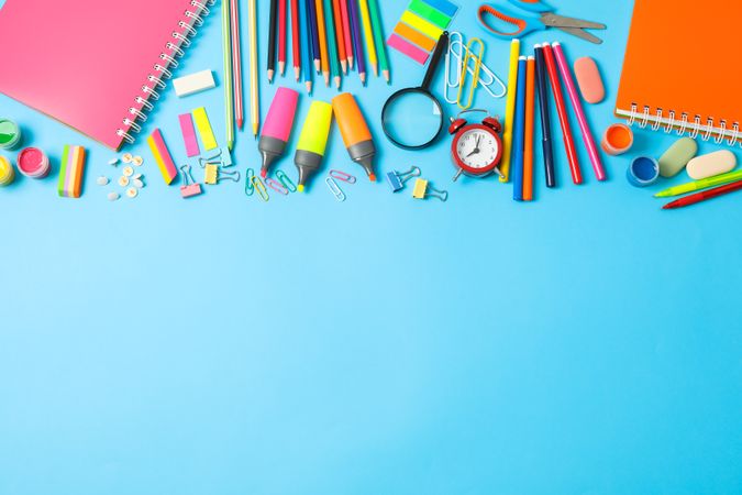 Flat lay composition with school supplies on color background, space for text