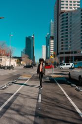 Woman with afro hair walking through the streets