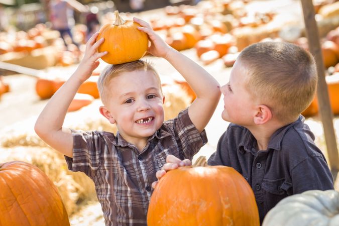 Two Boys at the Pumpkin Patch Talking and Having Fun.