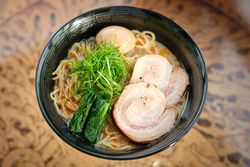 Palatable Japanese soup with noodles meat and nori served on table