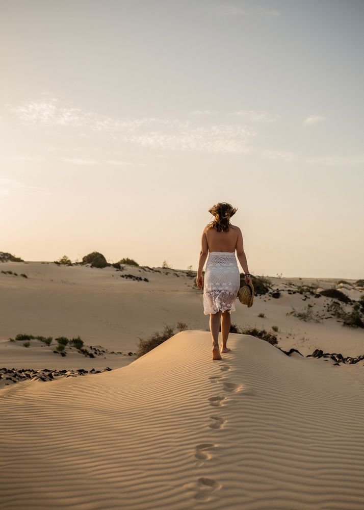 Active woman walking in dry desert barefoot