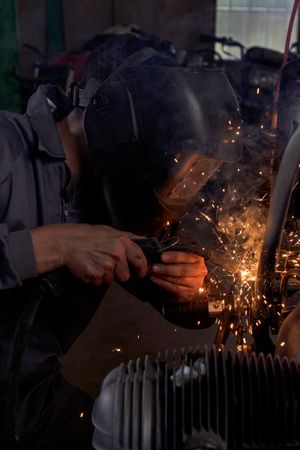 Experienced man working in custom made motorcycle workshop