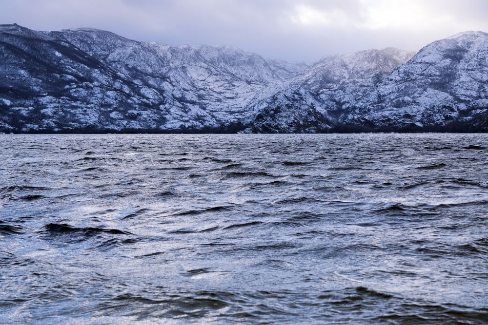 Shore with mountains near water