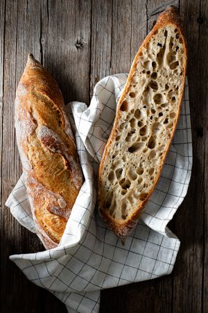 Fresh baguettes on checkered towel