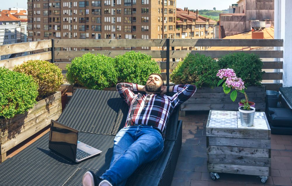 Businessman resting on lounger on terrace