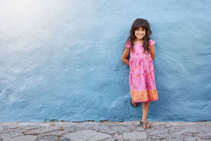 Full length portrait of cute little girl smiling