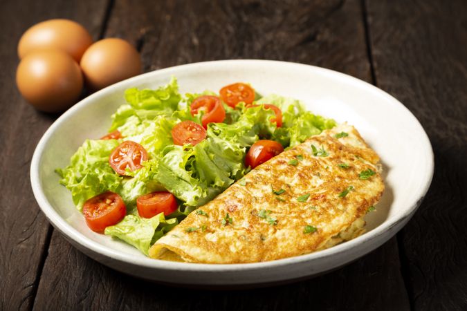 Omelet with cheese and lettuce and tomato salad.