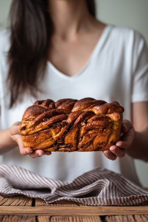 Faceless woman with appetizing cinnamon babka