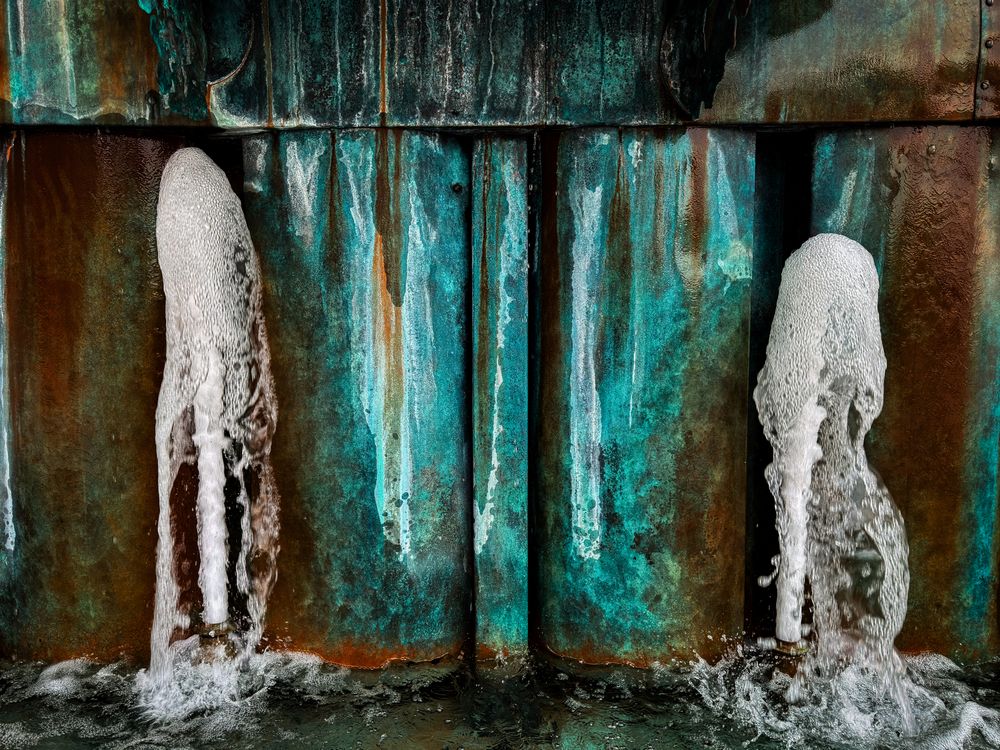 Metal fountain with green and orange corrosion