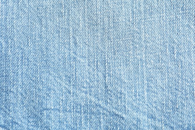 Texture of blue jeans as background, space for text