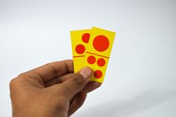 Hand holding two domino cards