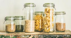 Variety of pasta, grains, and beans in glass jars 4MOKx0