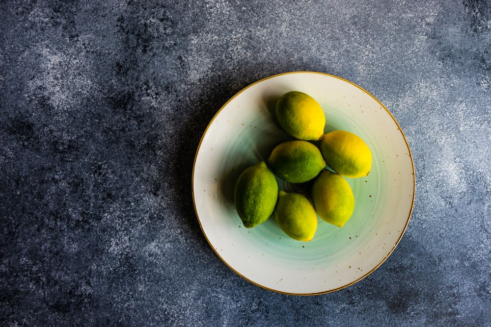 Plate of lemons at different levels of ripeness