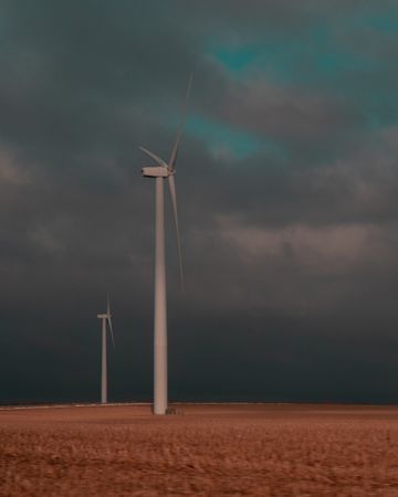 Wind turbine under gray clouds