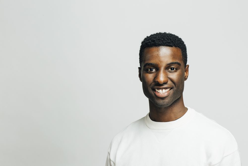 Happy Black man in a bright room with copy space