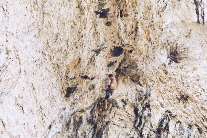 Anonymous man climbing rock