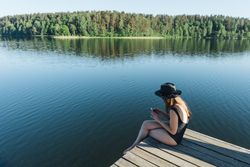 Young female sitting on smartphone