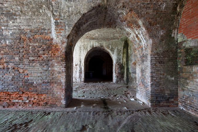 Old brick archways in empty chambers of Fort Morgan in Mobile, Alabama