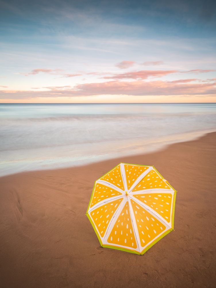 Umbrella on beach near sea