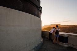 Two people looking at sunset view at Griffith Observatory in Los Angeles