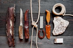 Top view of knives, rope, and matches