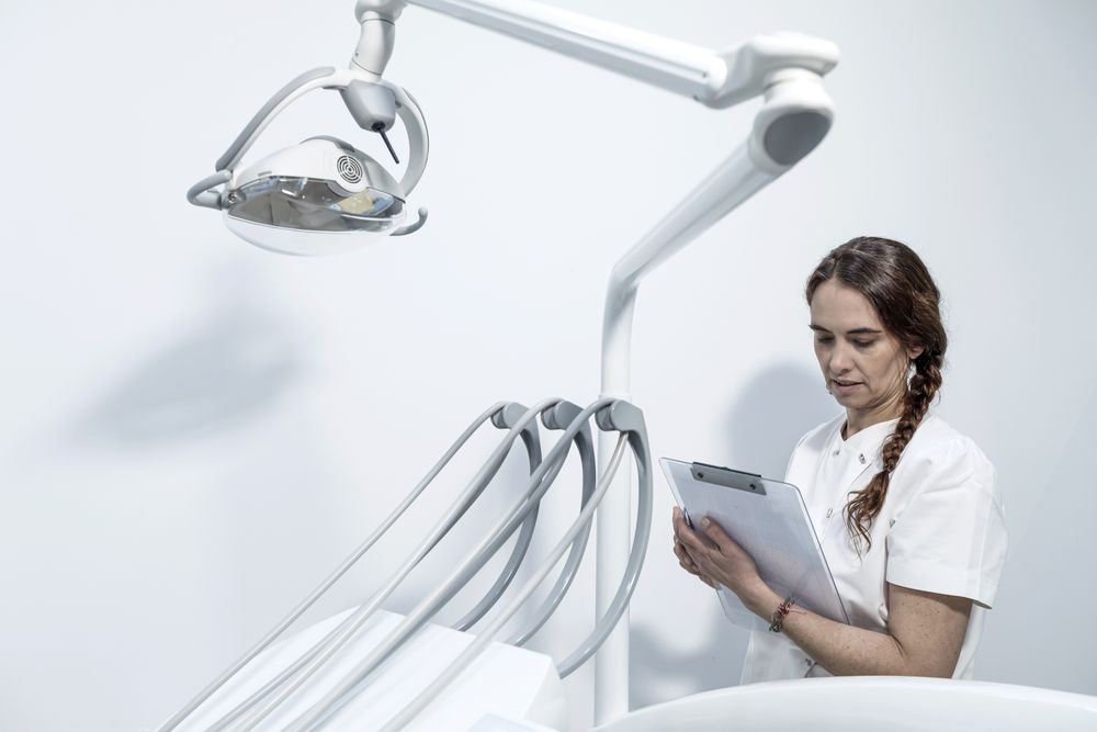 Portrait of an experienced doctor holding clipboard with documents