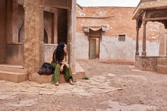Woman on street between ancient buildings