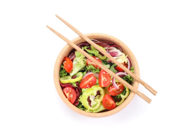 Fresh salad and chopsticks isolated on blank background