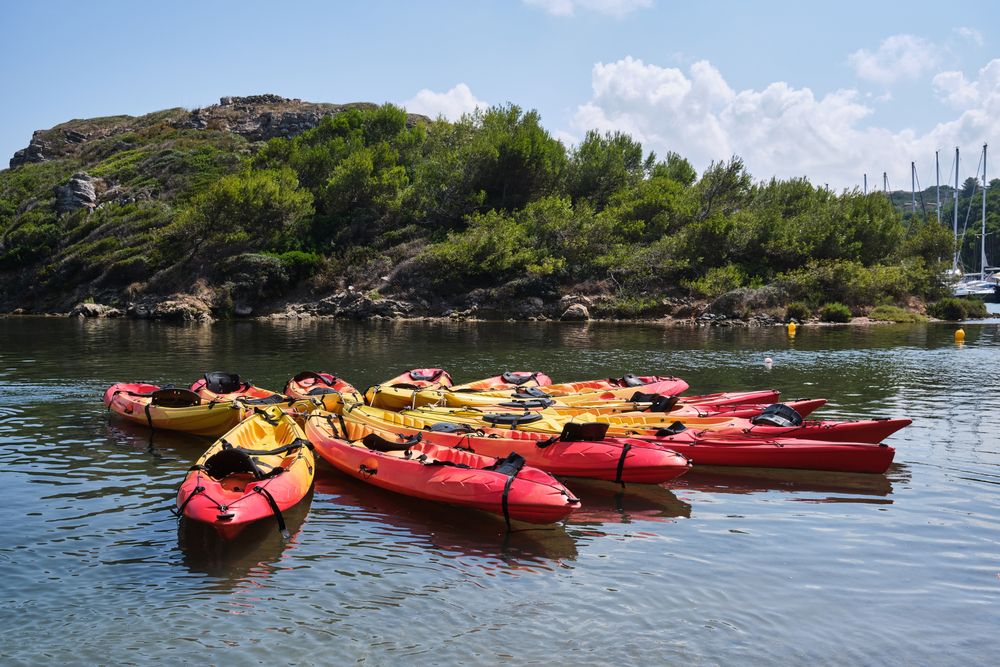 Colorful kayaks on rippling sea