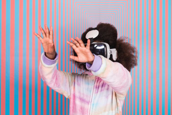 Black girl using VR goggles in studio