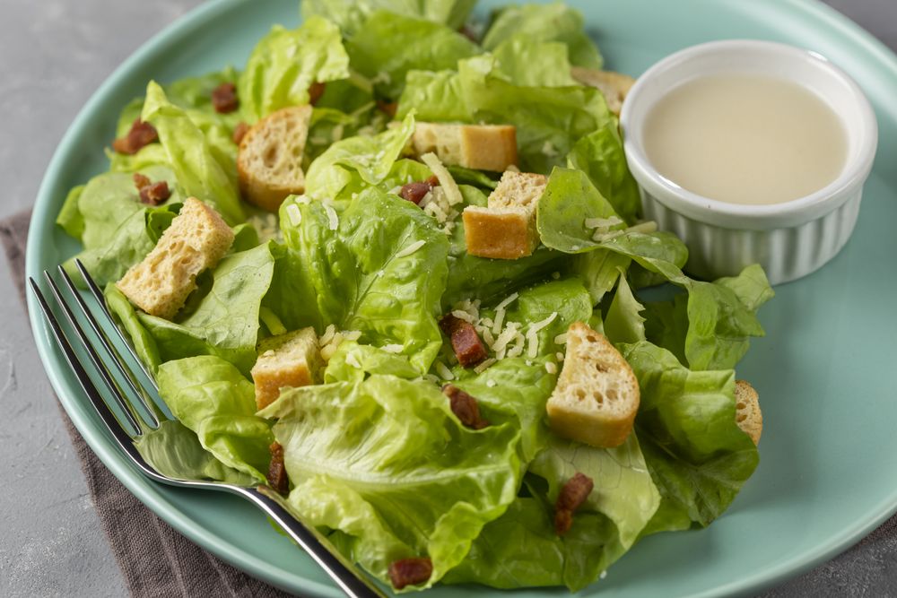 Caesar salad with croutons and bacon.