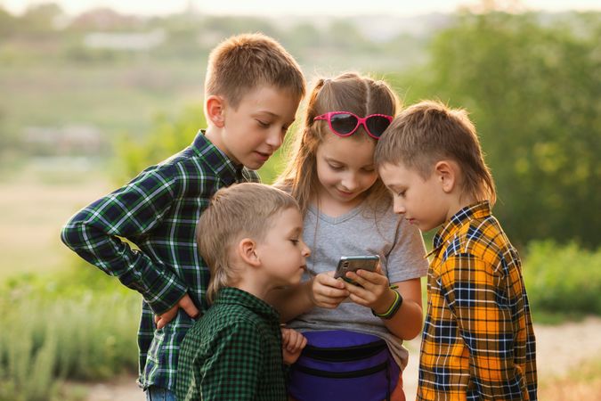 Group children playing with mobile phone