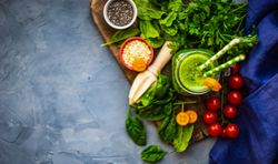 Green smoothie ingredients of apple, baby spinach, cucumber, chia seeds on concrete background with copy space