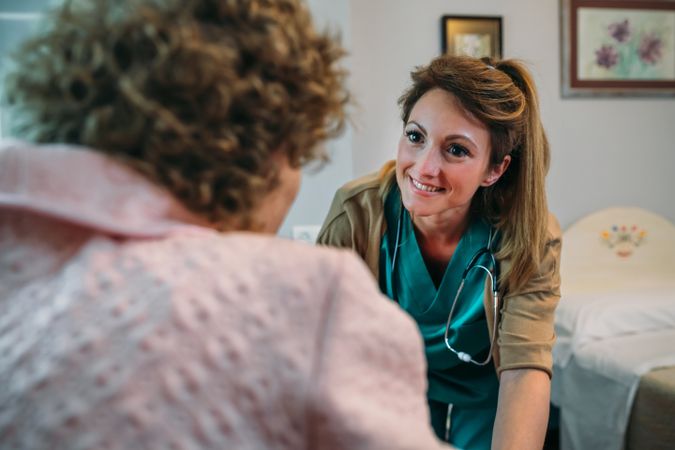 Doctor talking to mature patient in a wheelchair