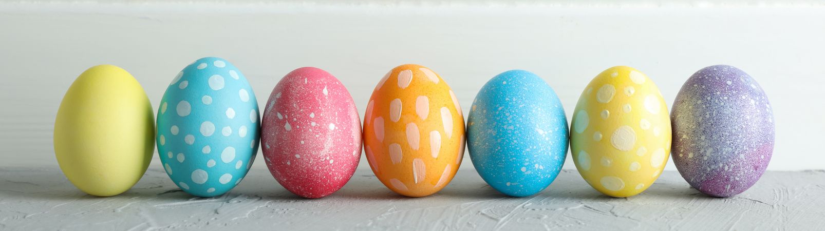 Decorated Easter eggs on color background, closeup. Space for text