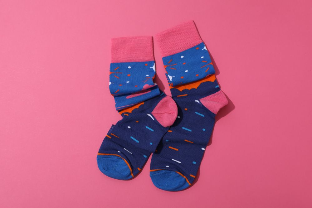 Casual clothes and wearing concept - socks, clothes for foot