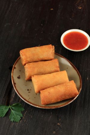 Plate of Chinese spring rolls served with dipping sauce